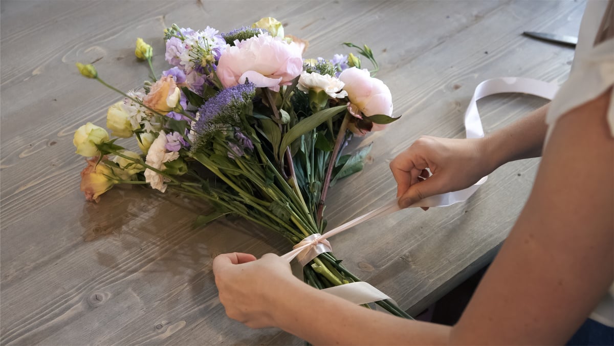 Creating flower bouquet in workshop.